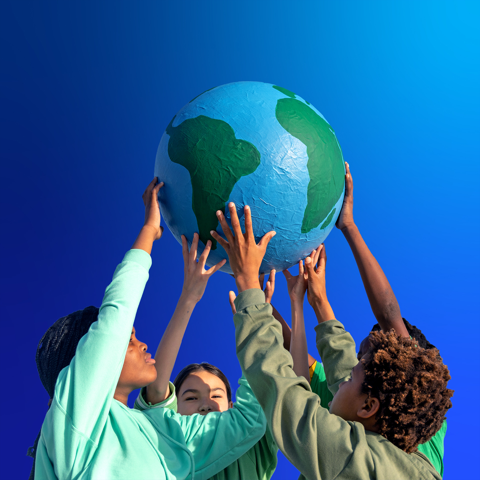 Group of children working together to hold up the world - stock photo